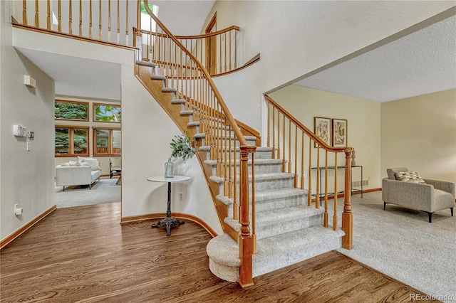 19149 E Ida Dr, Aurora, CO 80015 - stairs featuring wood finished floors, baseboards, and a high ceiling