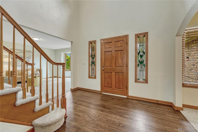 19149 E Ida Dr, Aurora, CO 80015 - entrance foyer featuring wood finished floors, baseboards, stairway, and a high ceiling