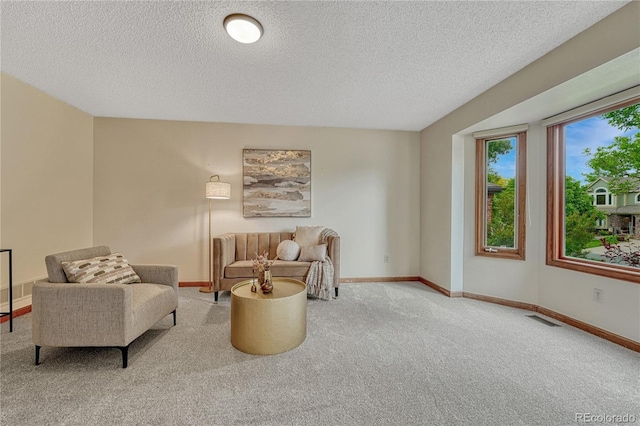 19149 E Ida Dr, Aurora, CO 80015 - carpeted living room featuring a textured ceiling and baseboards