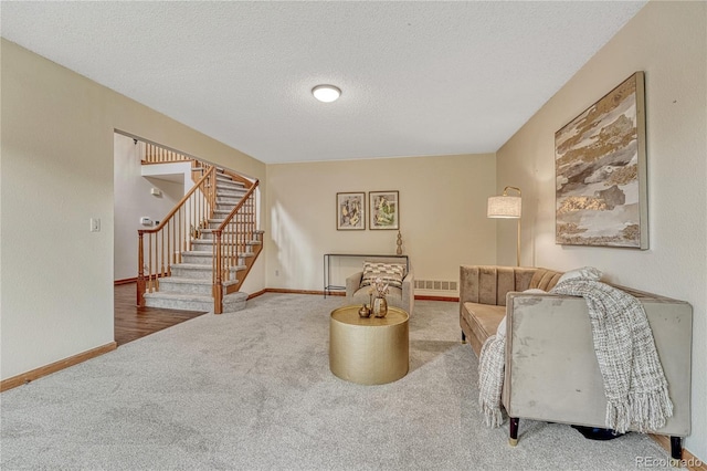 19149 E Ida Dr, Aurora, CO 80015 - carpeted living room featuring stairs, baseboards, and a textured ceiling