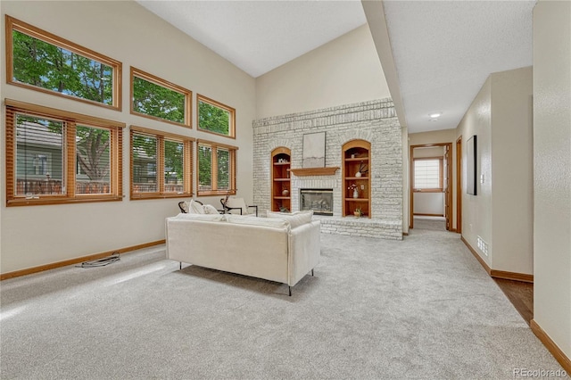 19149 E Ida Dr, Aurora, CO 80015 - living area featuring carpet floors, baseboards, built in shelves, a fireplace, and a towering ceiling