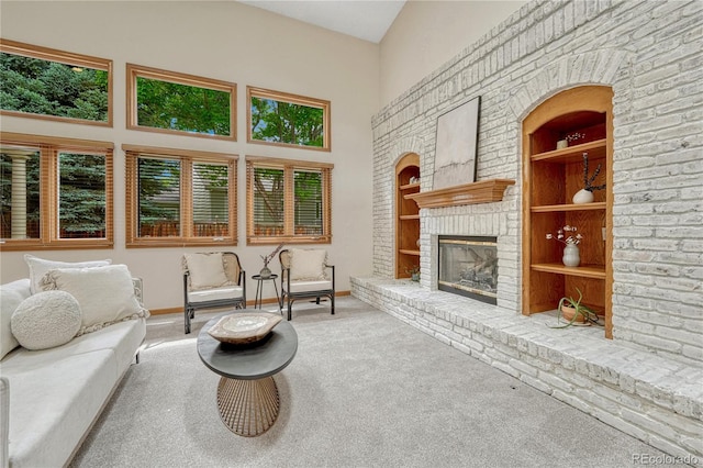 19149 E Ida Dr, Aurora, CO 80015 - carpeted living room with built in shelves, a fireplace, baseboards, and a towering ceiling