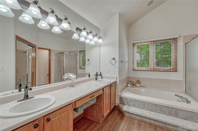 19149 E Ida Dr, Aurora, CO 80015 - full bath with a garden tub, a shower stall, lofted ceiling, double vanity, and wood finished floors