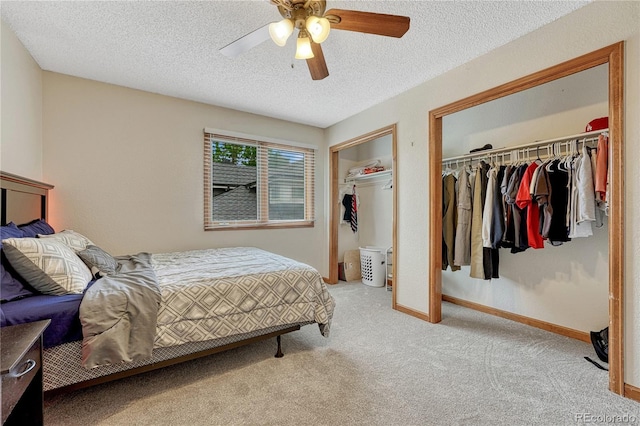 19149 E Ida Dr, Aurora, CO 80015 - bedroom featuring light carpet, a textured ceiling, ceiling fan, and two closets