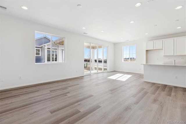 unfurnished living room with light wood-type flooring