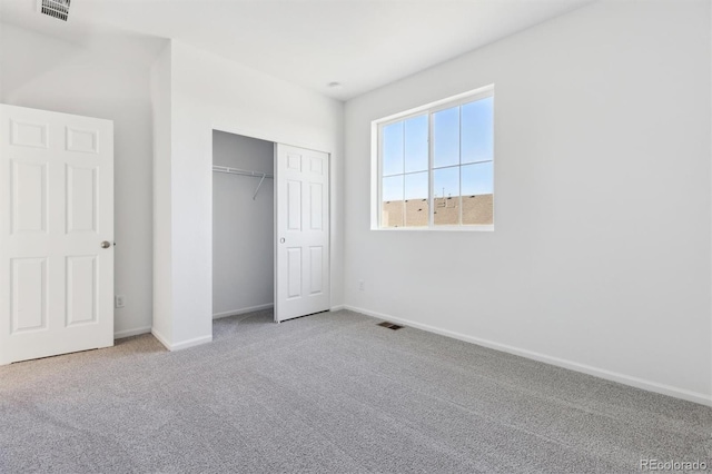 unfurnished bedroom featuring carpet floors and a closet