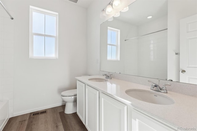 full bathroom featuring shower / bathtub combination, wood-type flooring, toilet, and vanity