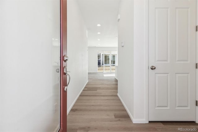 hallway with light hardwood / wood-style flooring