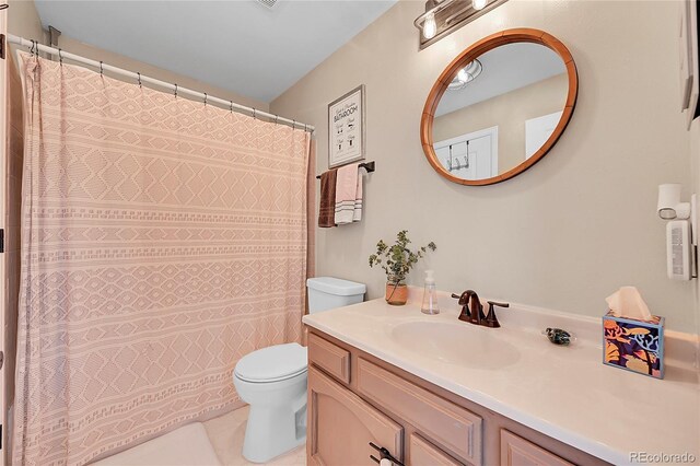 9446 W Wagon Trail Cir, Littleton, CO 80123 - bathroom with toilet, vanity, tile patterned flooring, and curtained shower
