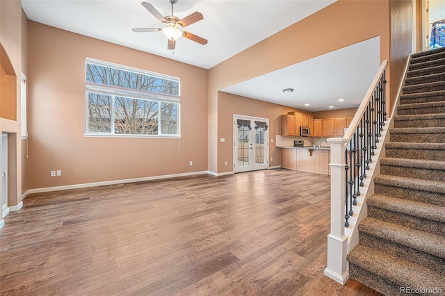 unfurnished living room with ceiling fan, light hardwood / wood-style floors, sink, and french doors