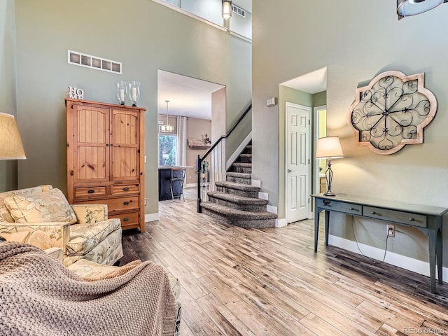 9867 Mulberry Way, Highlands Ranch, CO 80129 - living room with a towering ceiling, wood finished floors, and stairs