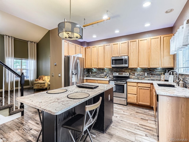 9867 Mulberry Way, Highlands Ranch, CO 80129 - kitchen with appliances with stainless steel finishes, light brown cabinetry, plenty of natural light, and recessed lighting