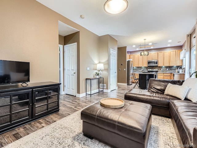 9867 Mulberry Way, Highlands Ranch, CO 80129 - living area with light wood-style flooring, recessed lighting, and a chandelier