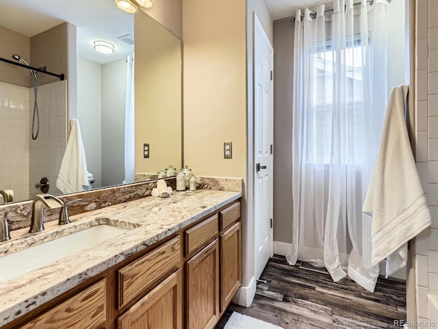 9867 Mulberry Way, Highlands Ranch, CO 80129 - bathroom featuring wood finished floors, vanity, and a shower