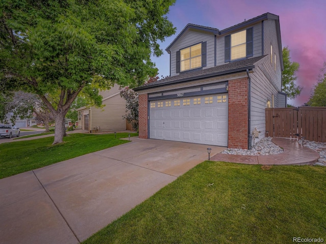 9867 Mulberry Way, Highlands Ranch, CO 80129 - traditional home featuring an attached garage, concrete driveway, and brick siding