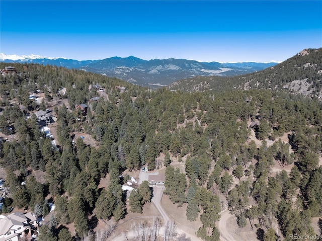 drone / aerial view featuring a view of trees and a mountain view