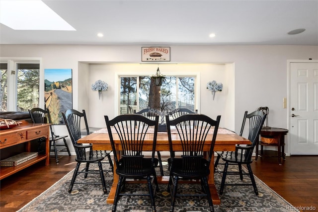 dining space with recessed lighting, a skylight, and dark wood-style floors