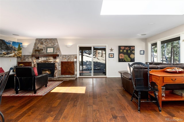 living area with hardwood / wood-style floors and a fireplace