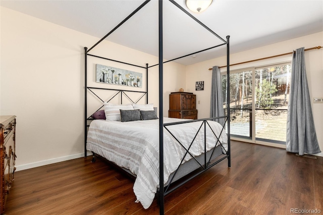 bedroom with baseboards and dark wood-style floors