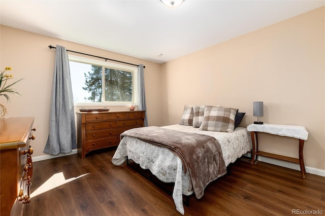 bedroom featuring baseboards and wood finished floors