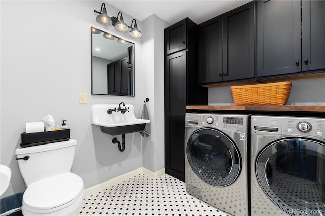 bathroom with tile patterned floors, a sink, toilet, baseboards, and independent washer and dryer