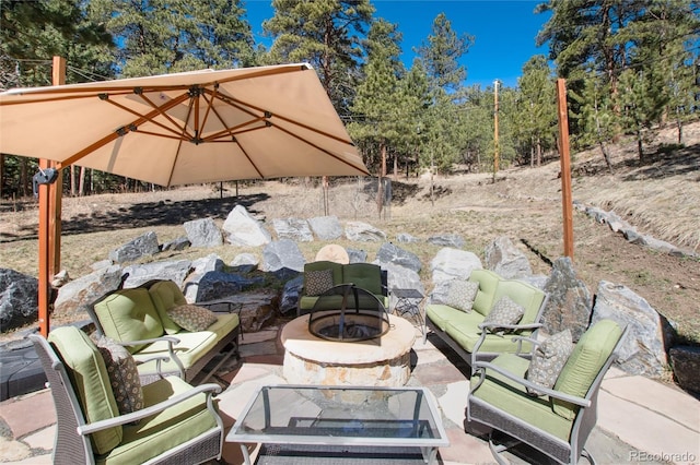 view of patio featuring an outdoor living space with a fire pit
