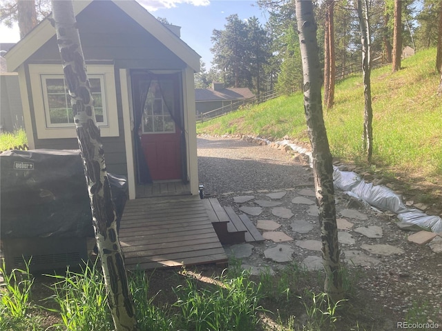 view of outbuilding with an outdoor structure and fence
