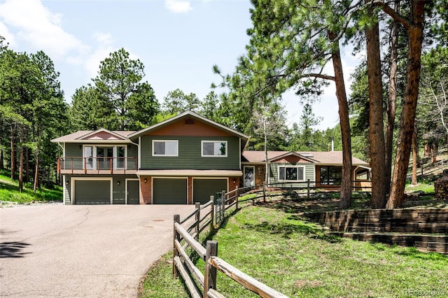 24949 N Mountain Park Dr, Evergreen, CO 80439 - view of front facade featuring an attached garage, asphalt driveway, and a balcony