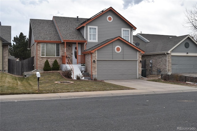 split level home featuring driveway, brick siding, a shingled roof, and fence