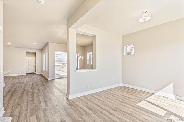 interior space featuring light hardwood / wood-style flooring and a notable chandelier