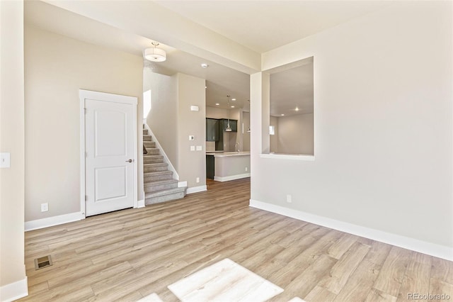 empty room featuring sink and light hardwood / wood-style floors