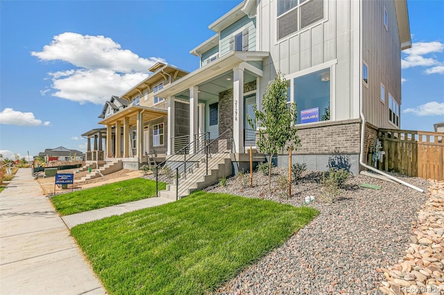 view of front of house with covered porch and a front yard