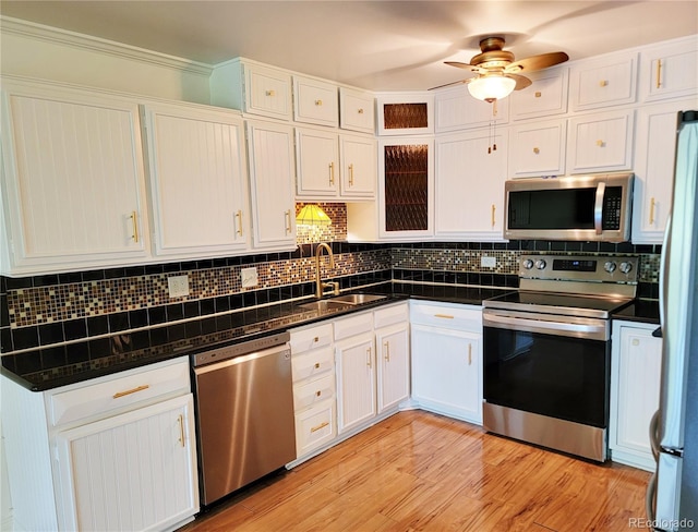 715 S Alton Way Unit 10A, Denver, CO 80247 - kitchen with stainless steel appliances, a sink, white cabinetry, and decorative backsplash