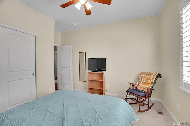 bedroom with a closet, ceiling fan, and carpet flooring