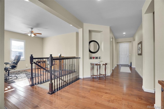 corridor with hardwood / wood-style floors