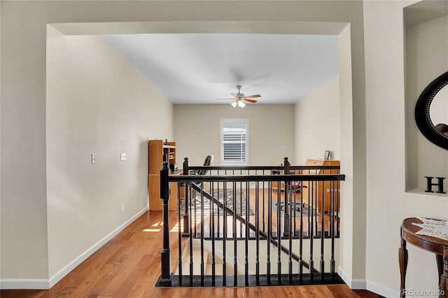 corridor with hardwood / wood-style flooring