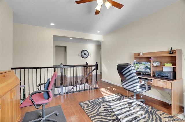 office with wood-type flooring and ceiling fan