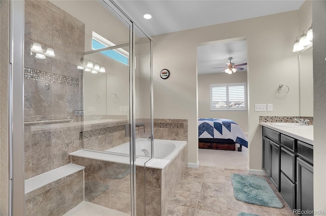 bathroom with ceiling fan, vanity, and independent shower and bath