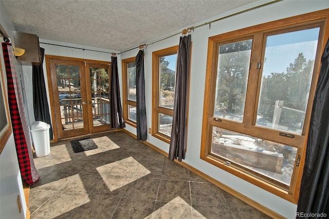 unfurnished sunroom featuring french doors and a healthy amount of sunlight