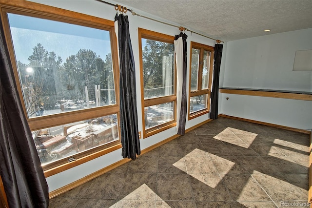 unfurnished room featuring a textured ceiling