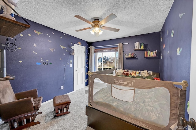 carpeted bedroom featuring ceiling fan and a textured ceiling