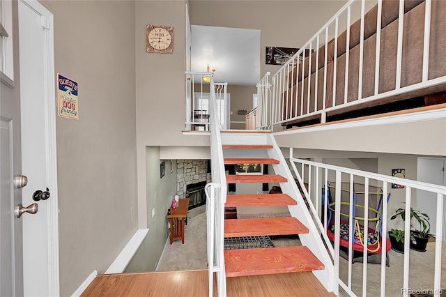 staircase featuring a fireplace