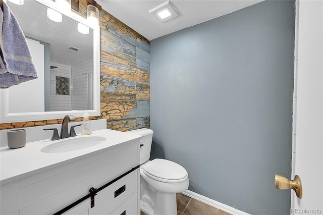 bathroom featuring tile patterned flooring, vanity, and toilet