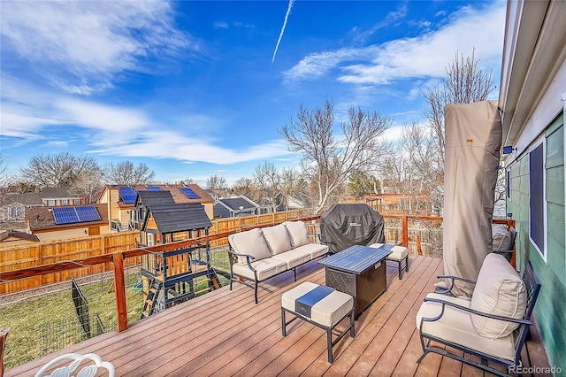 wooden terrace with outdoor lounge area and grilling area