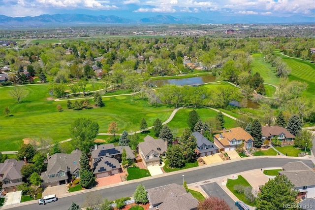 birds eye view of property featuring view of golf course, a residential view, and a water and mountain view