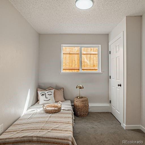 bedroom featuring carpet and a textured ceiling