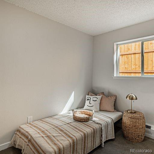 carpeted bedroom featuring a textured ceiling