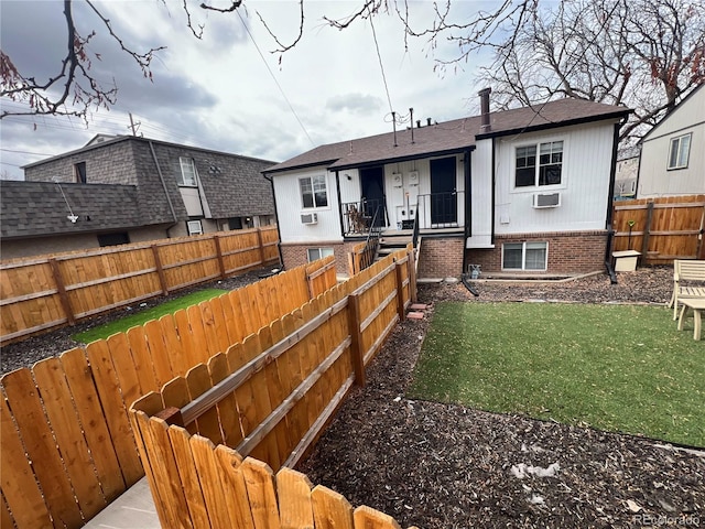 back of house featuring a yard