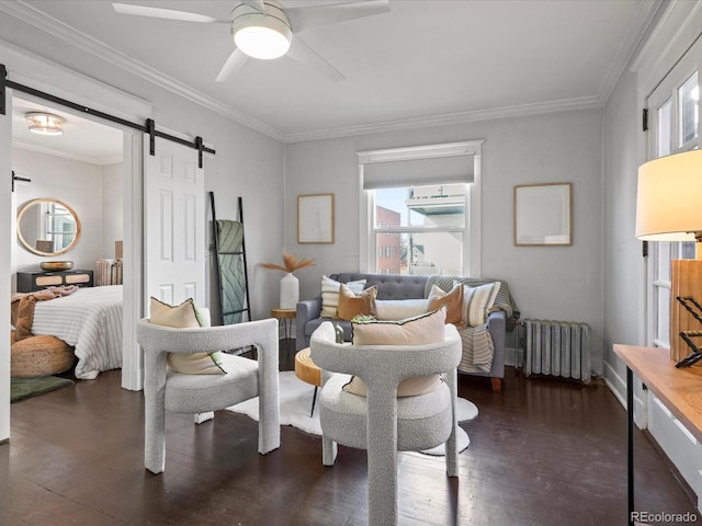 interior space with radiator, ceiling fan, crown molding, and a barn door