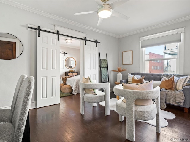 dining area with ceiling fan, a barn door, dark hardwood / wood-style flooring, and ornamental molding